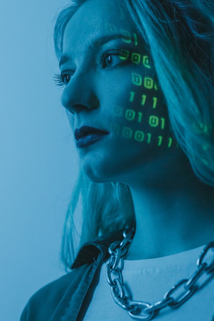 The Art of Drawing Readers In: Your attractive post title goes here Tech-inspired portrait of a woman with digital code projected on her face, symbolizing cybersecurity.